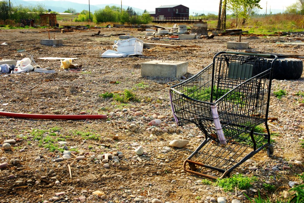 The image shows an abandoned shopping cart in field symbolising the issues surrounding churn customers.