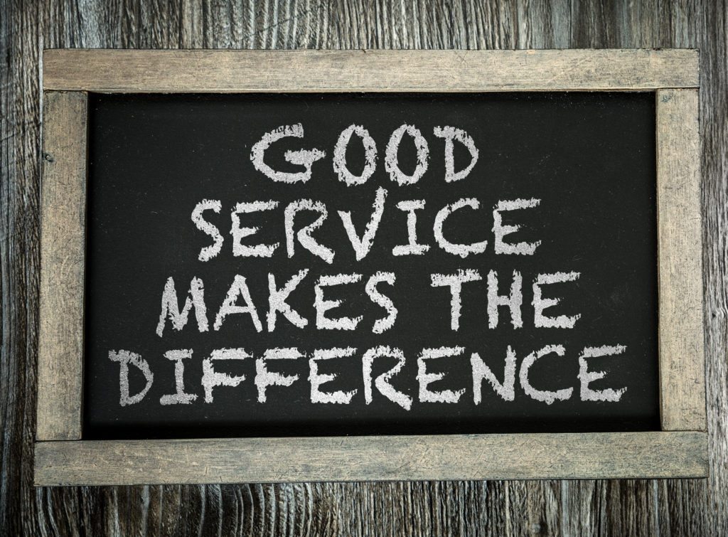 Good customer service is important. Image shows a chalk board with the words good service makes the difference.