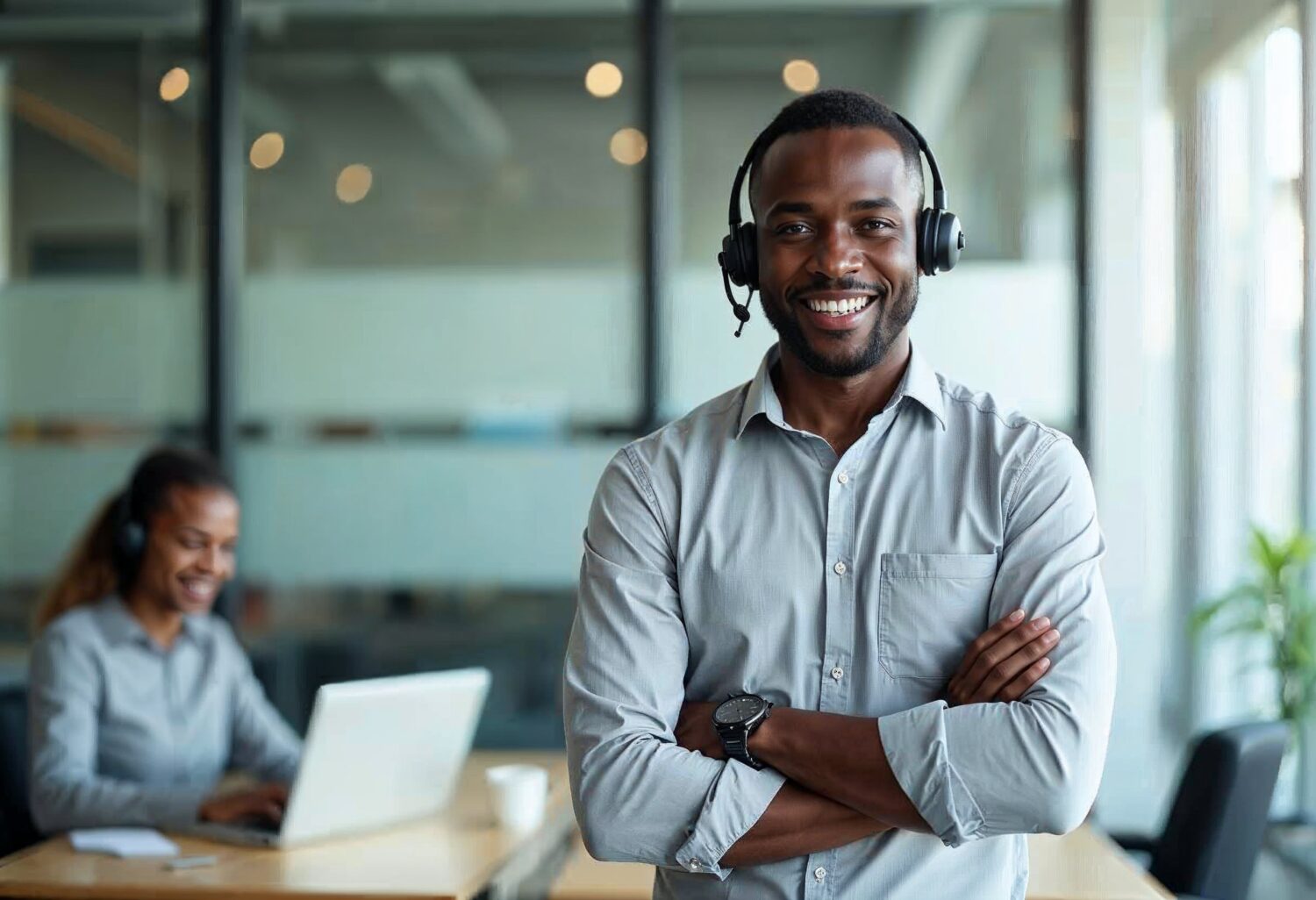 Smiling customer service team with headsets and laptop, illustrating efficient handling of customer inquiries in insurance.